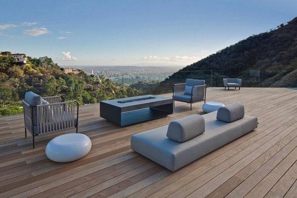 Contemporary patio with outdoor wood and sandstone fireplace