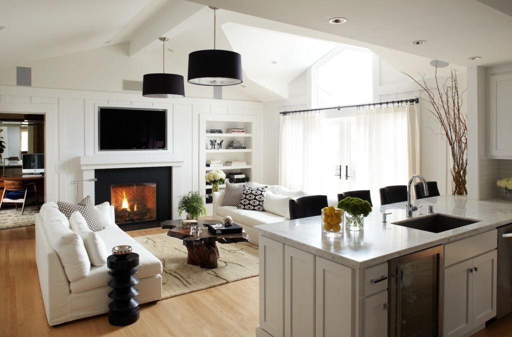 A portal fireplace with a TV placed above it is the central composition of the living room
