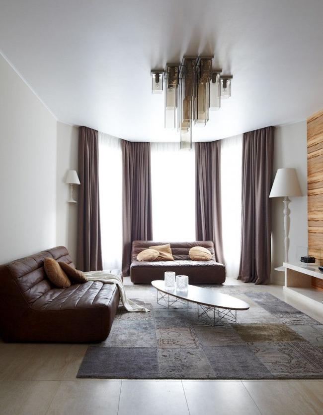 White stretch ceiling will help emphasize the severity of the living room