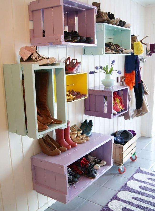 Wooden crates on the wall are a great idea for a homemade shoe rack