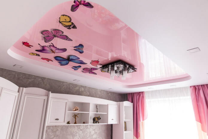 a white and pink two-level ceiling with a photo print in the form of butterflies.
