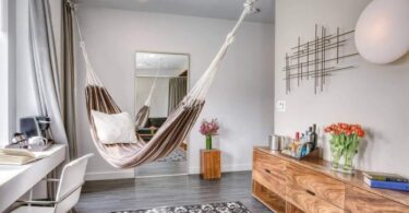 unusual hanging hammock bed in the interior of a city apartment.
