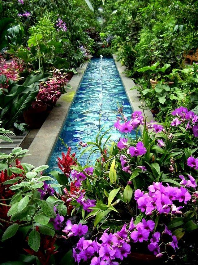 Artificial pond in lush garden thickets