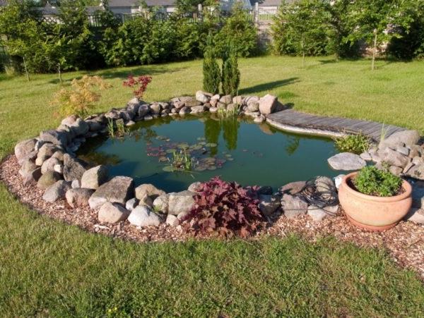 Framing the banks of the pond with natural stone