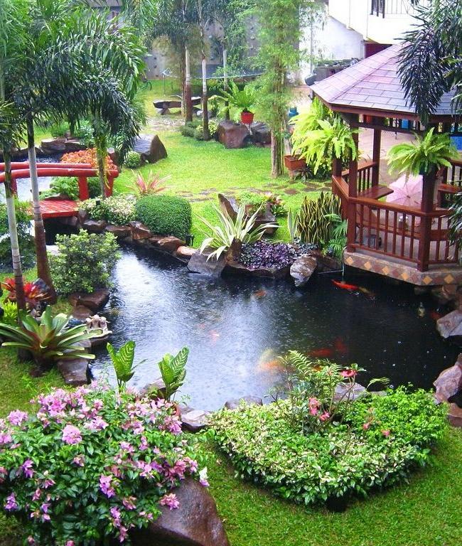 Large artificial pond with pergola and bridge