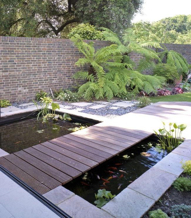 Rectangular artificial pond with wooden bridge